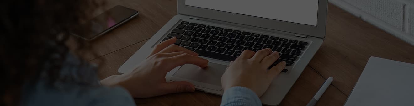 Someone typing on a laptop